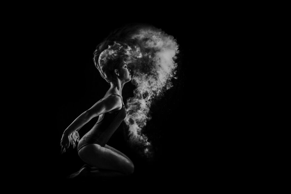 ballerina in bianco e nero con fumo attorno alla testa